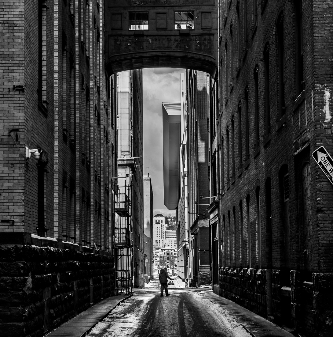 Man Walking in Sunlit Alley 
