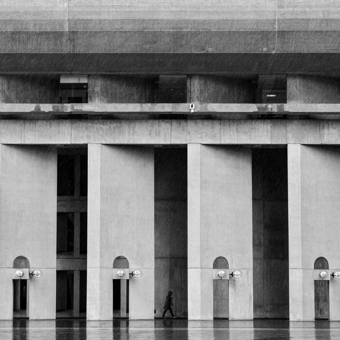 Woman Under Rainy Pillars